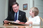 Charlotte at our dining room table sharing her project with our state senator.